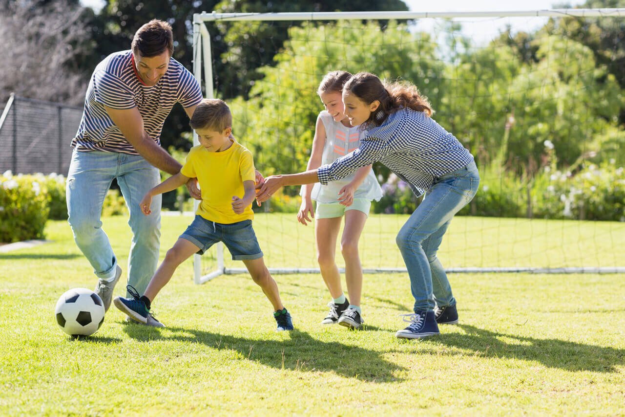 ankored-happy-family-playing-football-together-at-the-park