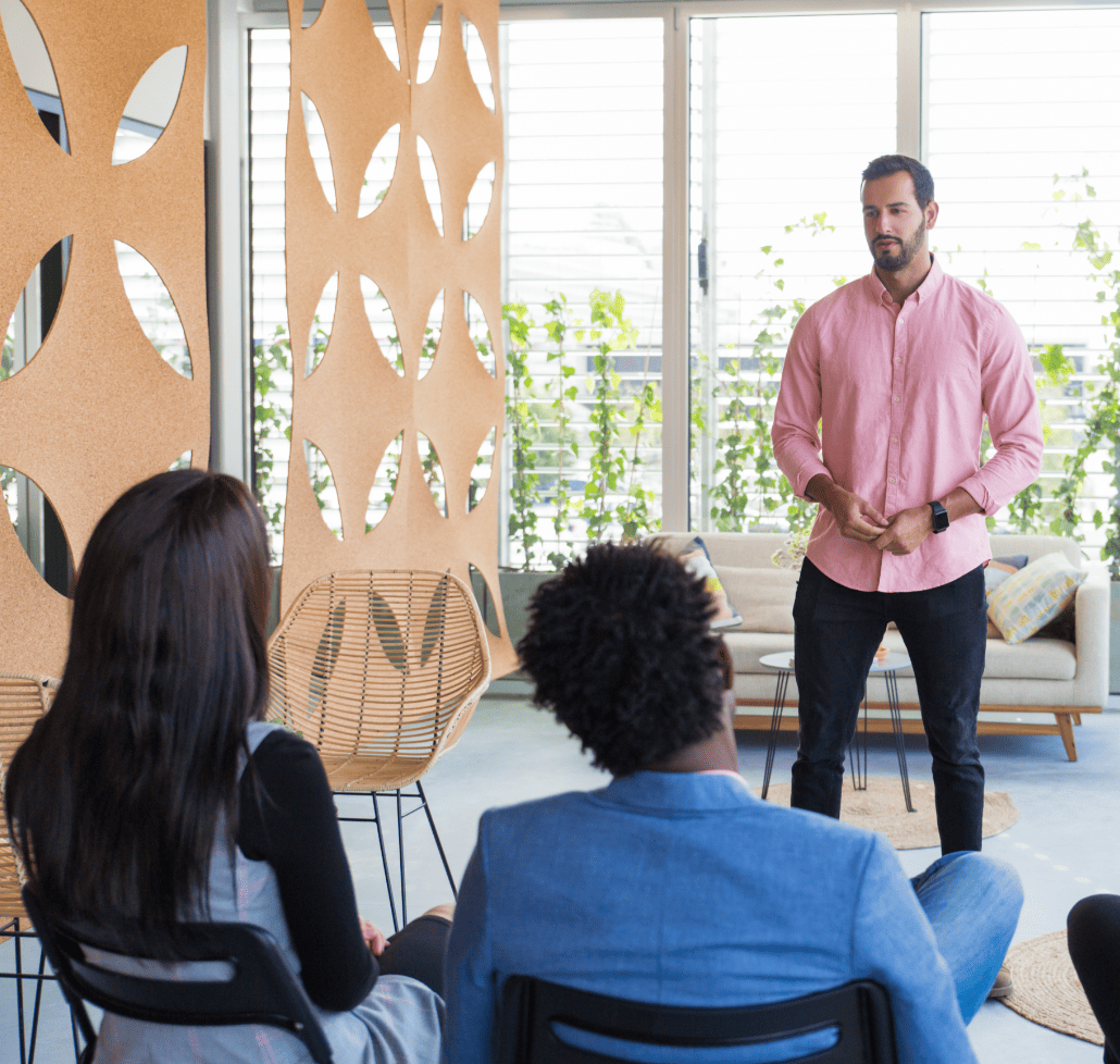 serious-confident-male-coach-holding-seminar